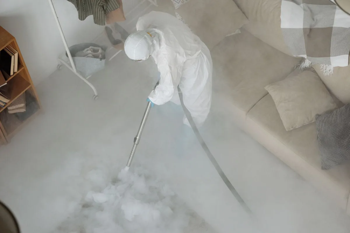 Biohazard cleanup technician in protective equipment, Jackson, MO